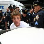 Protester Charlie Meyers is arrested during the afternoon march